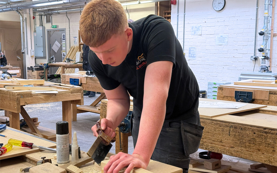 Joinery student sawing