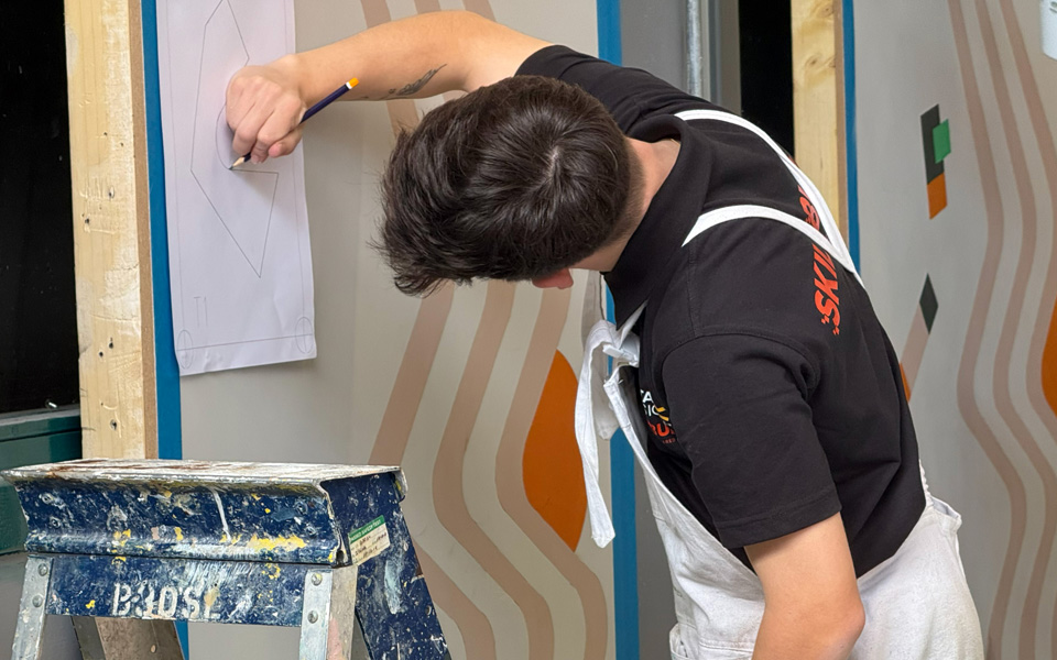 Painting and decorating student working on drawing