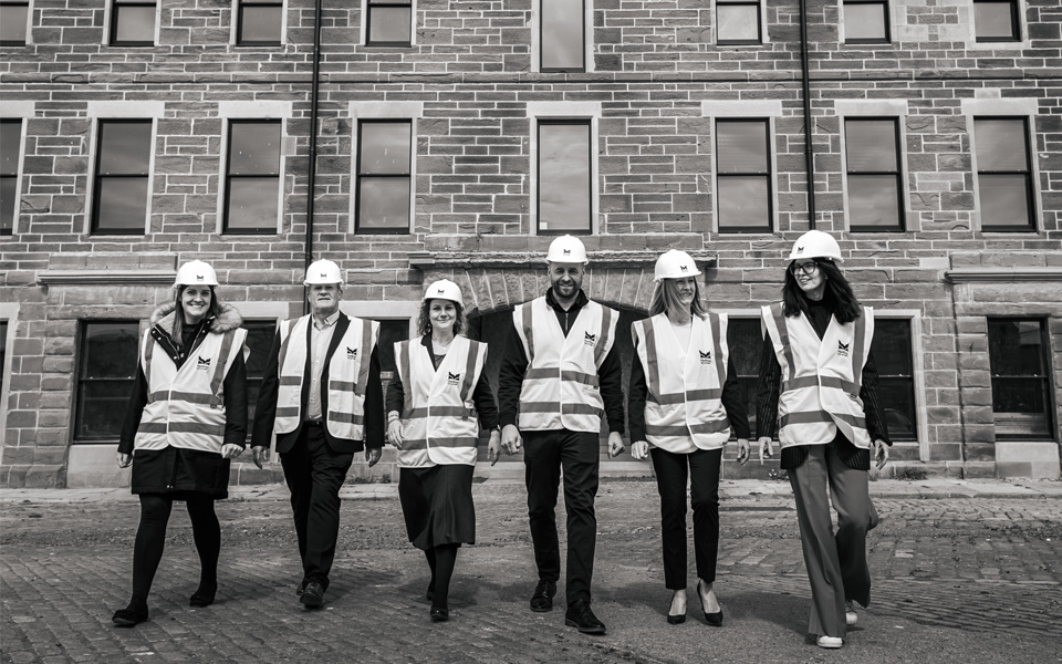 Group of staff from Inchcape and Dundee and Angus College walking away from Montrose Port Skill Academy building in a line