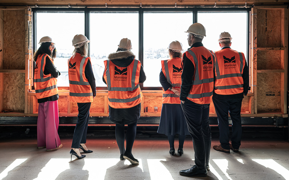 Staff wearing high vis jackets looking around Montrose Port Skills Academy