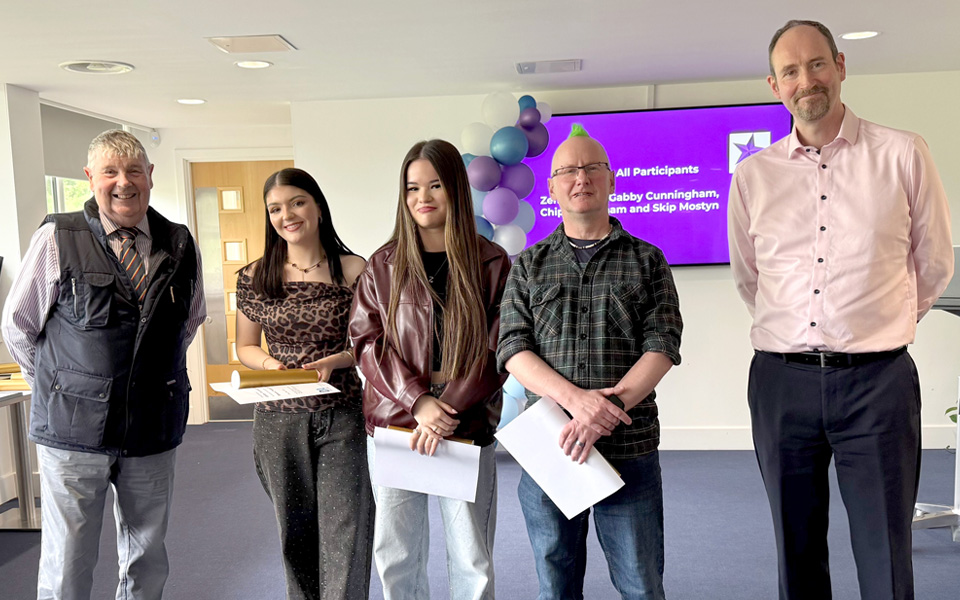 Students holding certificates with two members of the Bakers Trade of Dundee