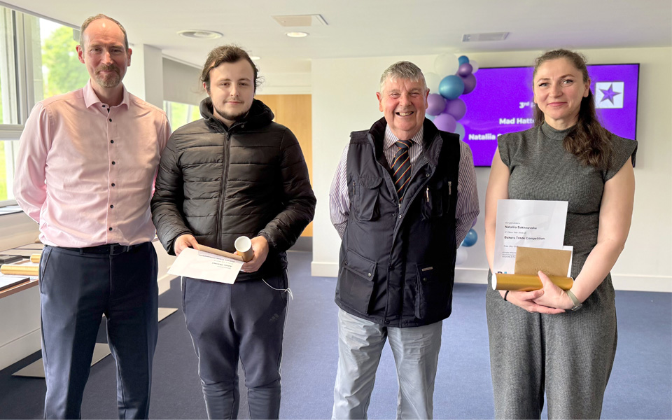 Students holding certificates with two members of the Bakers Trade of Dundee