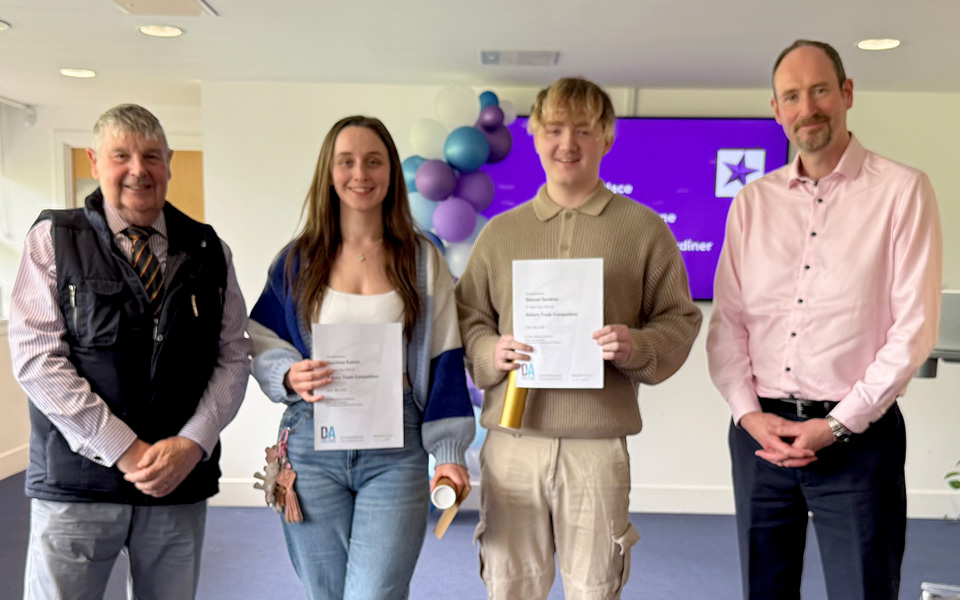 Students holding certificates with two members of the Bakers Trade of Dundee