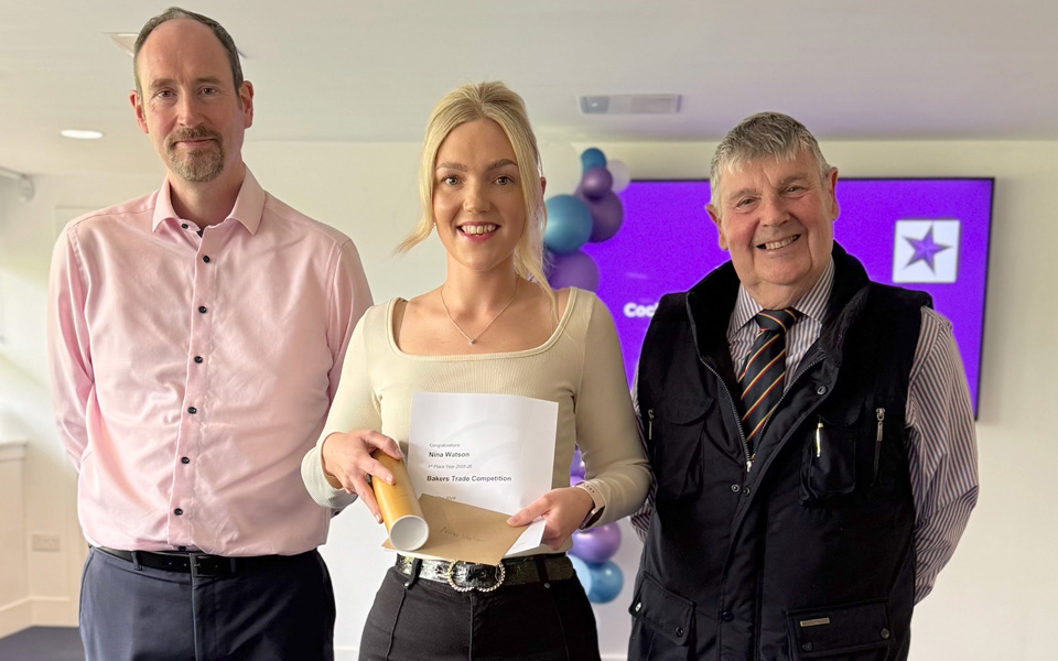 Student holding certificate with members of the Bakers Trade of Dundee
