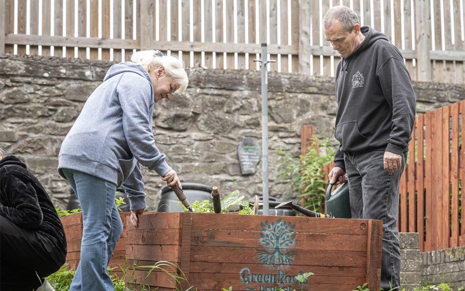 Green Roots Project volunteers working with garden bed