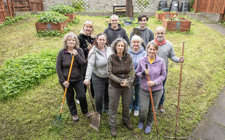Group of Green Roots Project volunteers in garden