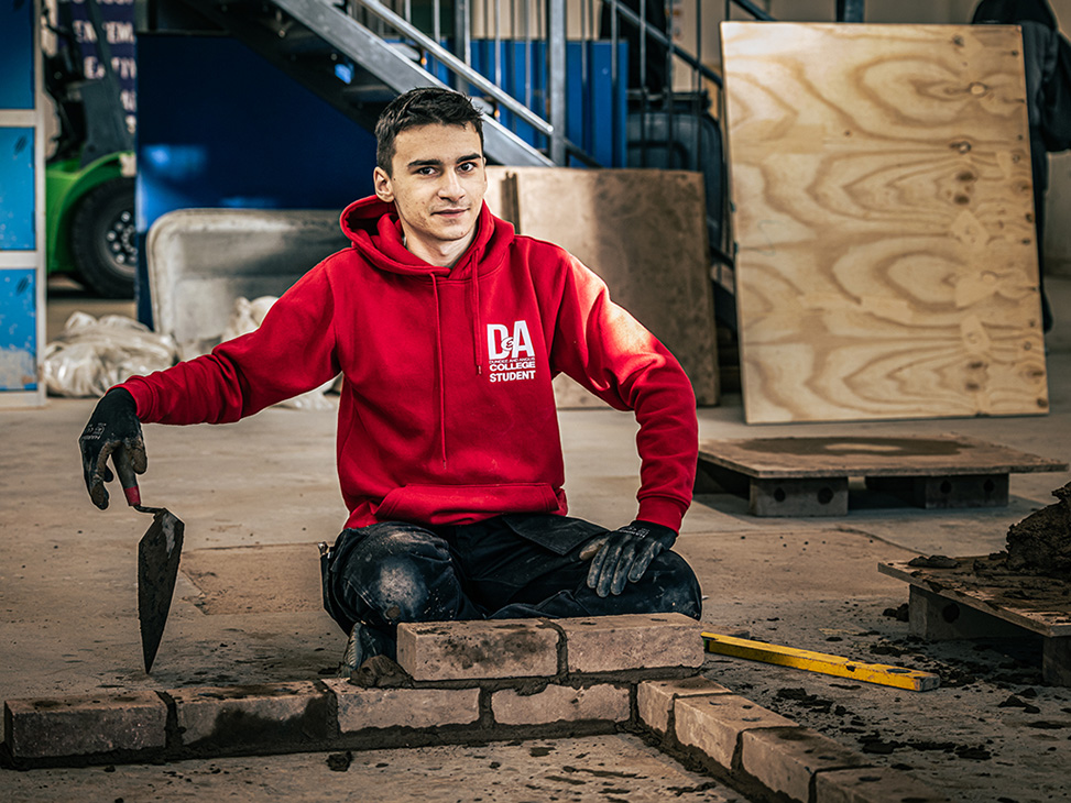 Student practices bricklaying