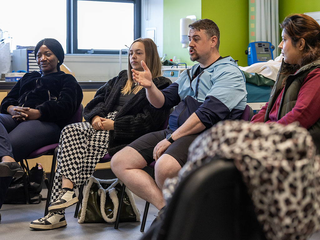 Four adults in group class discussion 