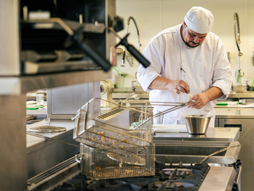 Cookery student in chef-whites