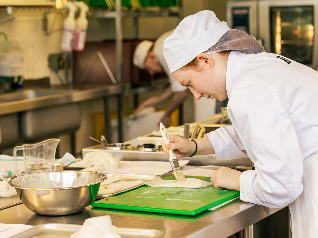 Student working on a dish