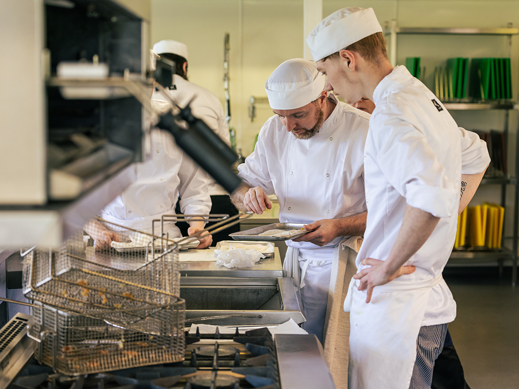 Students prepare food for the deep-fryer