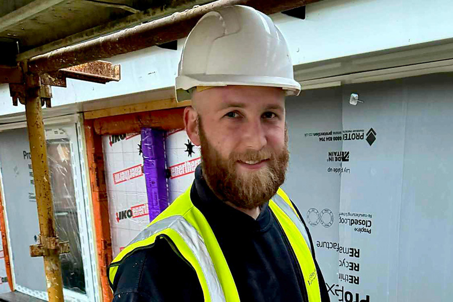 Student wearing construction helmet and high vis
