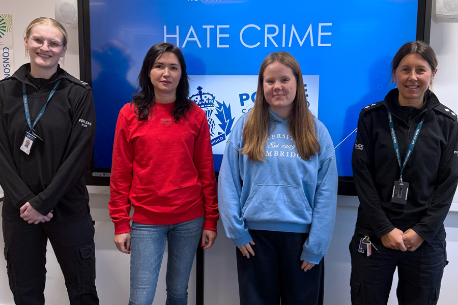 Police studies students with police officers standing in front of presentation