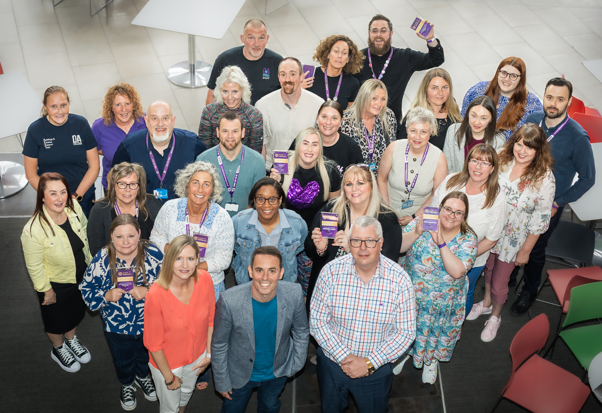 Principal and VPs of D&A College stand with a group of award winning staff at the colleges 2025 Staff Award Ceremony)